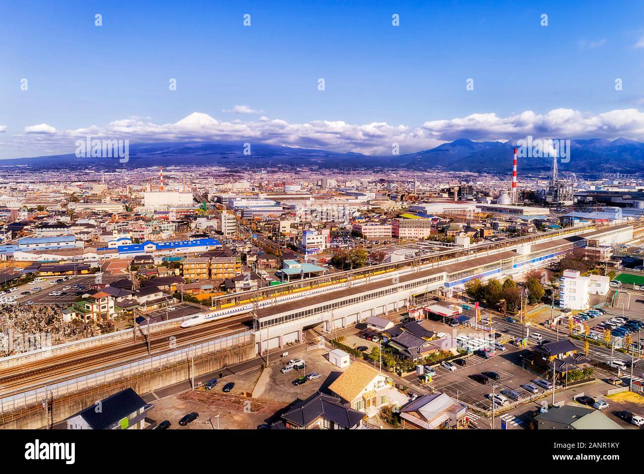 Shin-Fuji train station for  express bullet trains in view of majestic Mt Fuji in Japan on a sunny day. Stock Photo