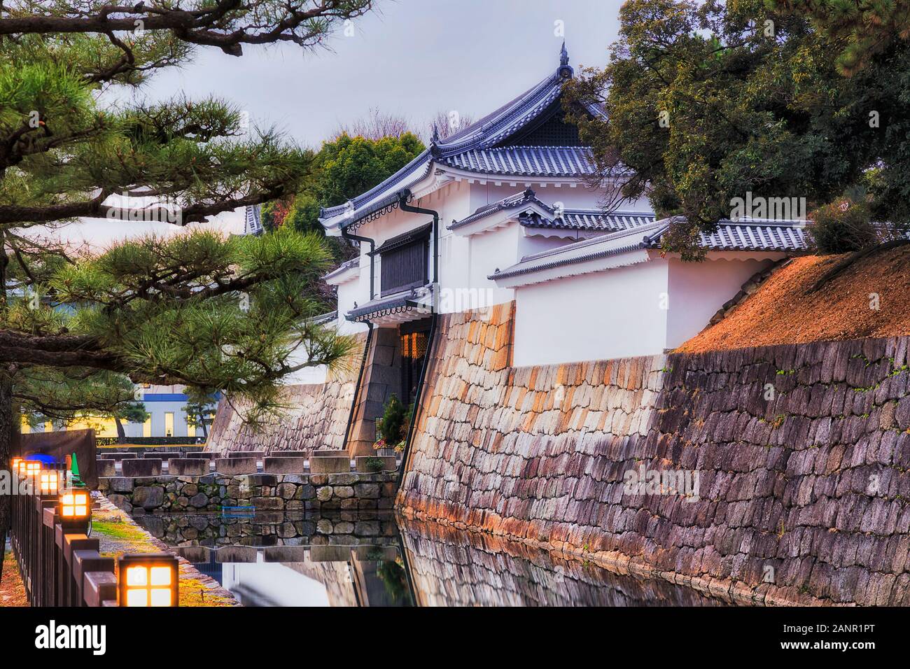 WHite tower and entrance gate to Nijo caste in Kyoto city - historic castle of local Shogun - present park, garden and heritage site surrounded by sto Stock Photo