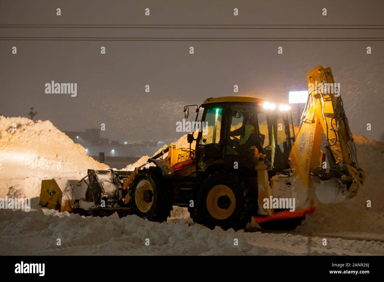 Manitowoc, WI USA January 18 2020 night snow removal from the parking