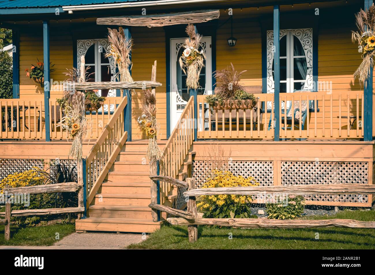 Typical country porched house in orange and blue. Canada. Rural life ...