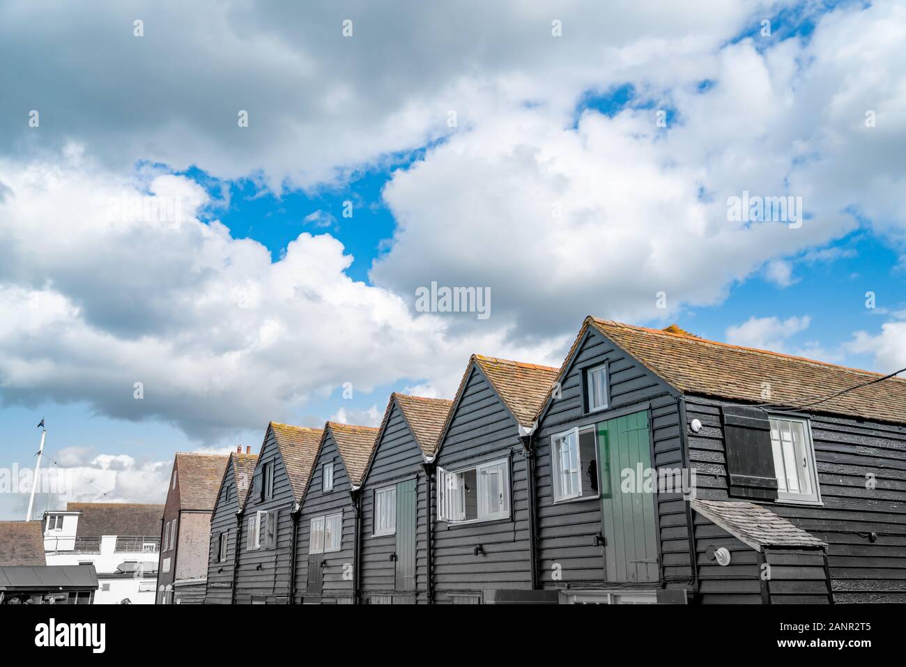 Black row of terrace style holiday homes from converted boatsheds in ...