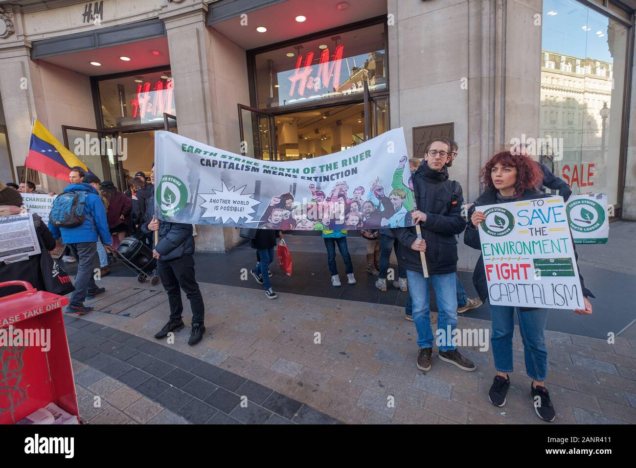 London, UK. 18th January 2019. Earth Strike protest at H&M at Oxford Circus  because of its involvement in the plunder of the planet, people and  resources. The fashion industry is the second