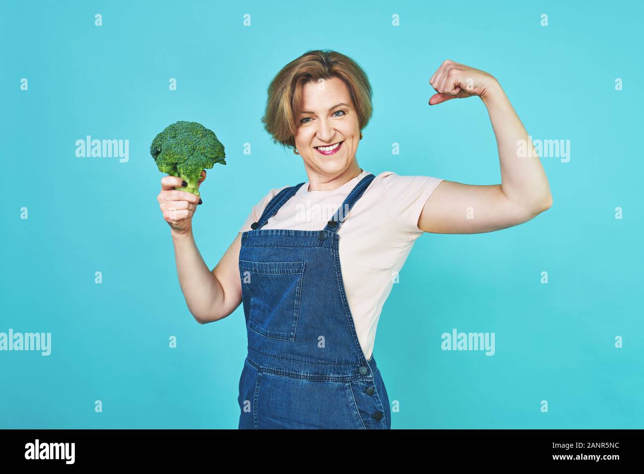 An aged woman is about to eat a vegetarian dish. Funny old woman on a