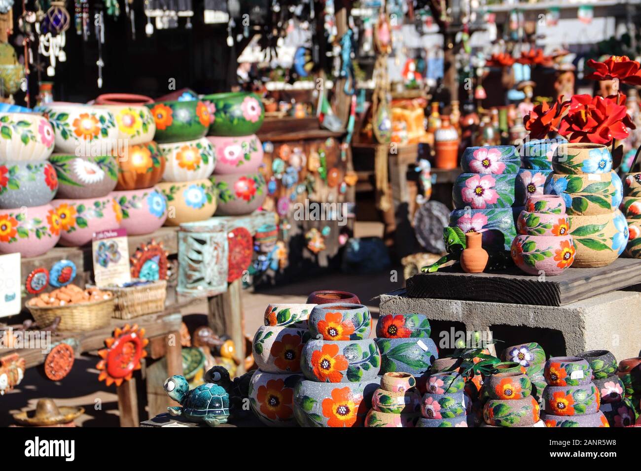 Bright colorful Mexican pottery stacked on display for sale Stock Photo