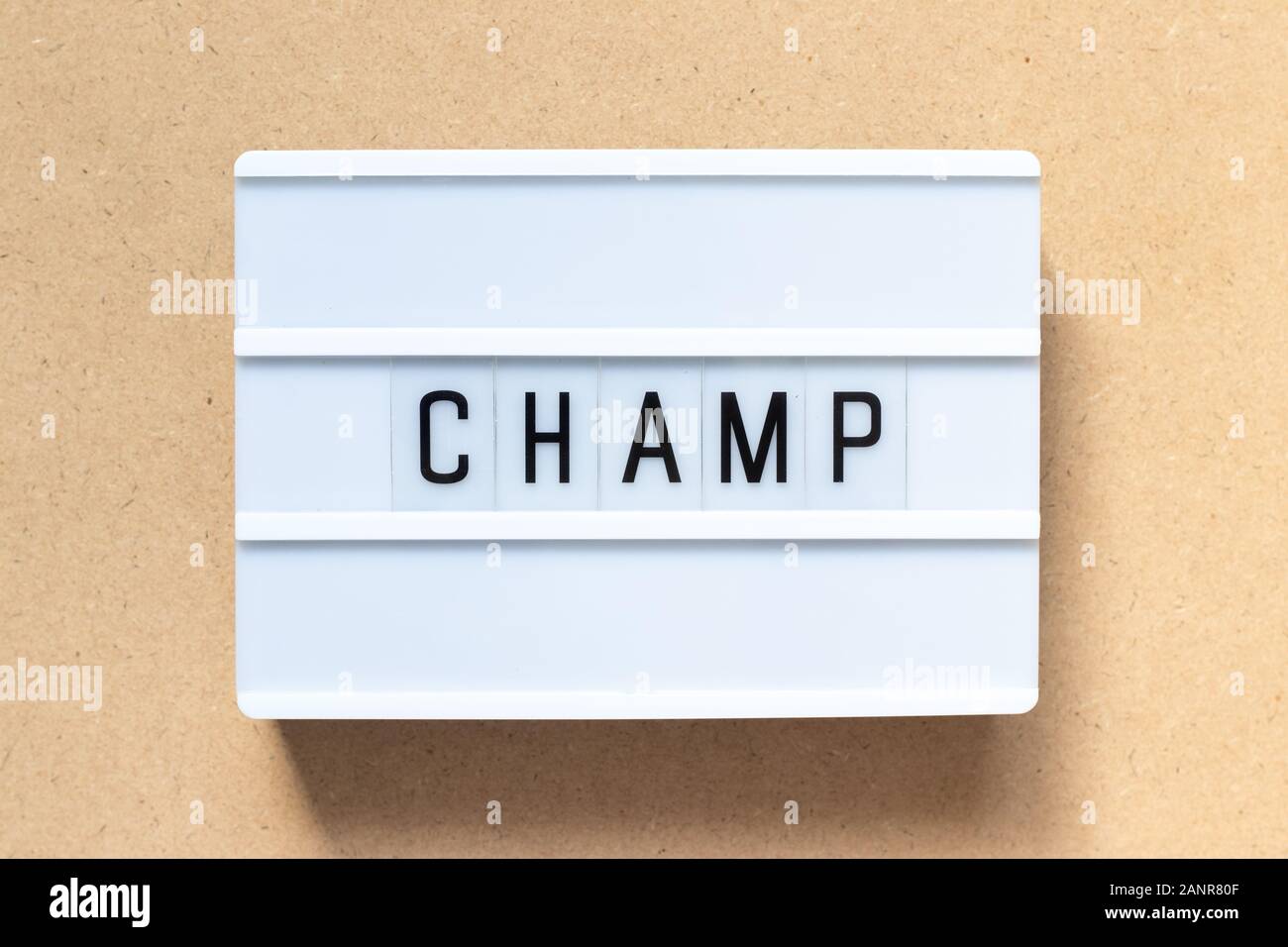 White lightbox with word champ on wood background Stock Photo