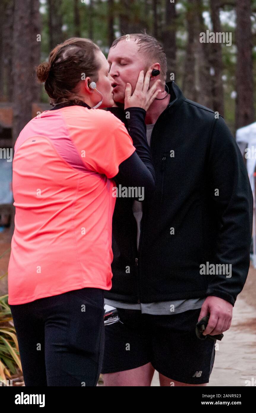 Southern Pines, North Carolina, USA. 18th Jan, 2020. Jan. 18, 2020 - Southern Pines N.C., USA - JEN HAMNER from Pinehurst, North Carolina kisses her husband and relay partner, JOHN HAMNER from Pinehurst, North Carolina during the Weymouth Woods 50 Mile Trail Run and Relay at the Weymouth Woods Nature Preserve. Runners and two-person relay teams were given 15 hours to complete the ten-lap, 5-mile course. Credit: Timothy L. Hale/ZUMA Wire/Alamy Live News Stock Photo