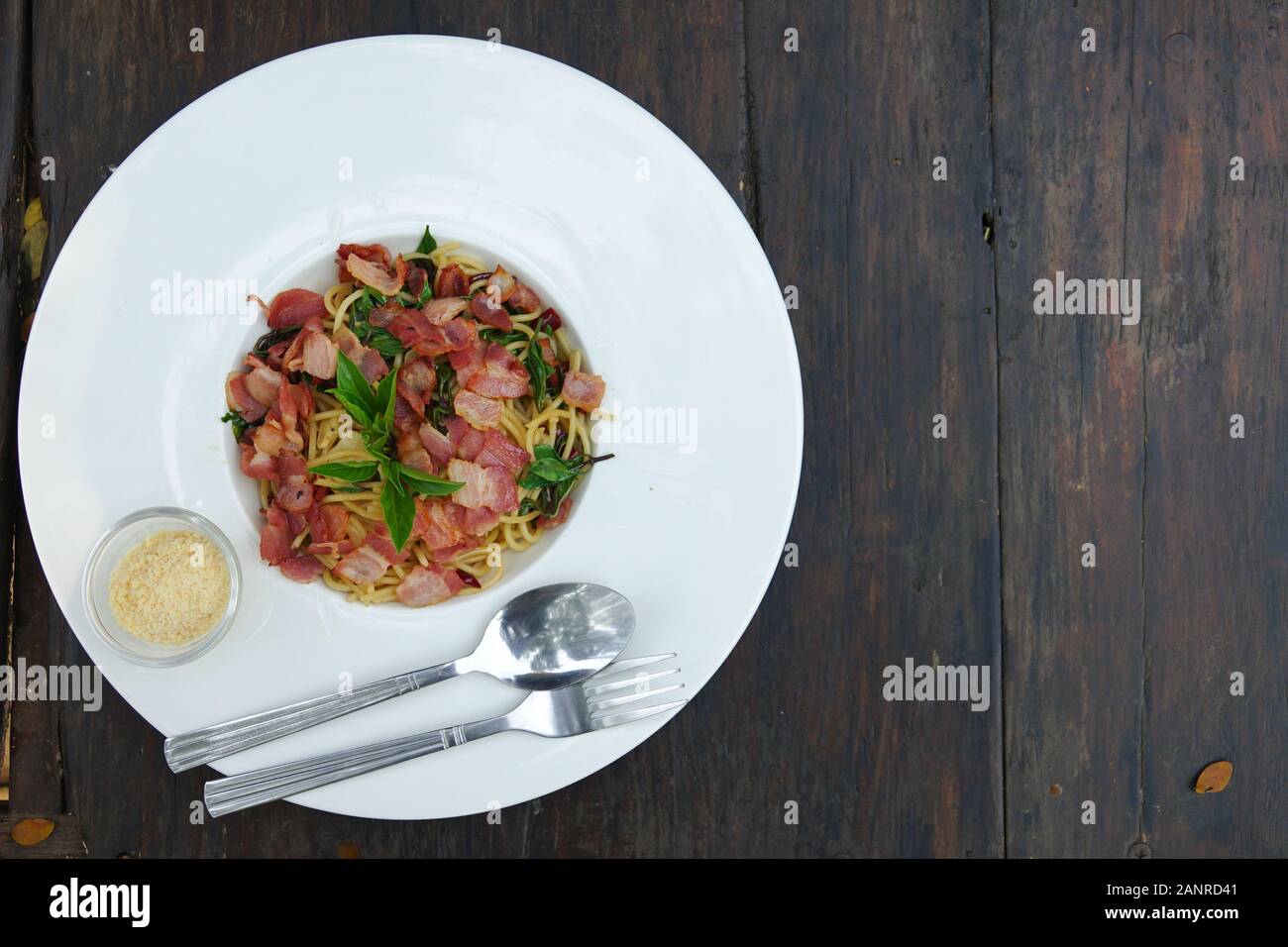The spaghetti spicy bacon and ham with basil Stock Photo