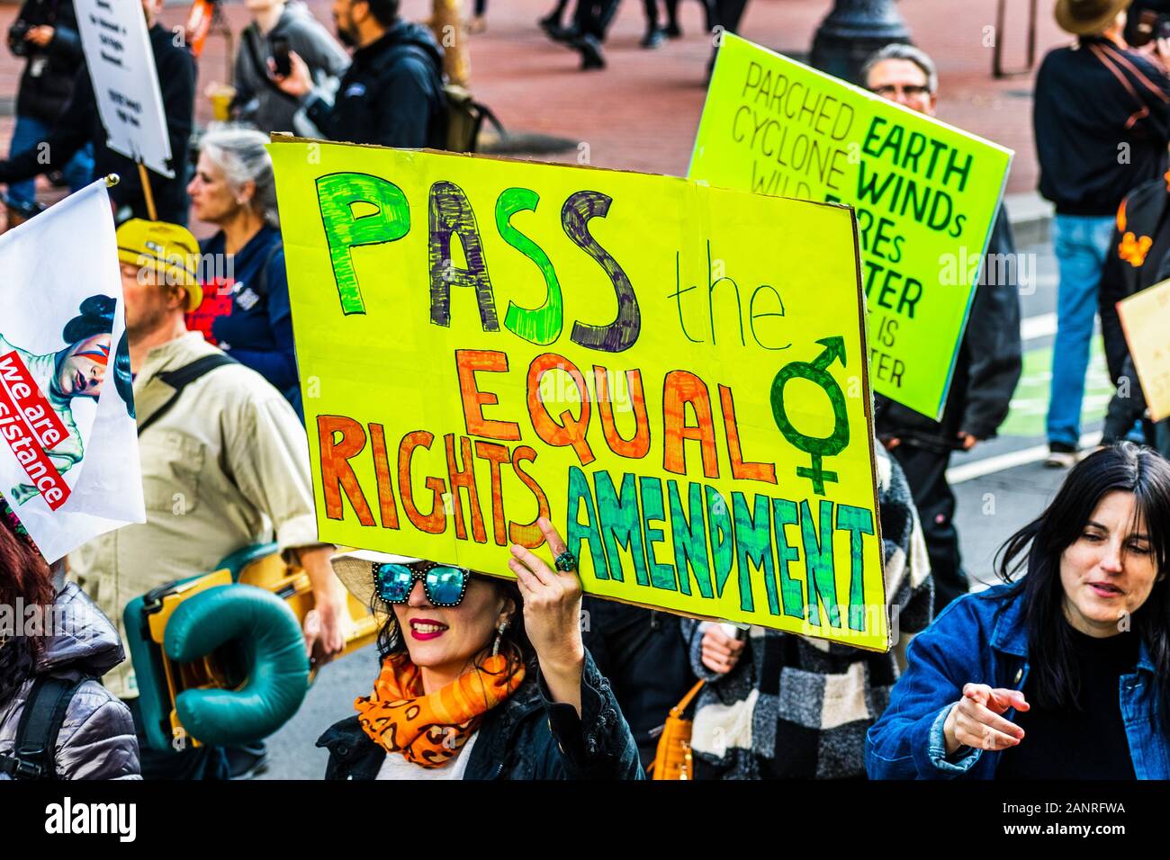 Jan 18, 2020 San Francisco / CA / USA - Participant to the Women's March event holds 'Pass the Equal Rights Movement' sign while marching on Market st Stock Photo