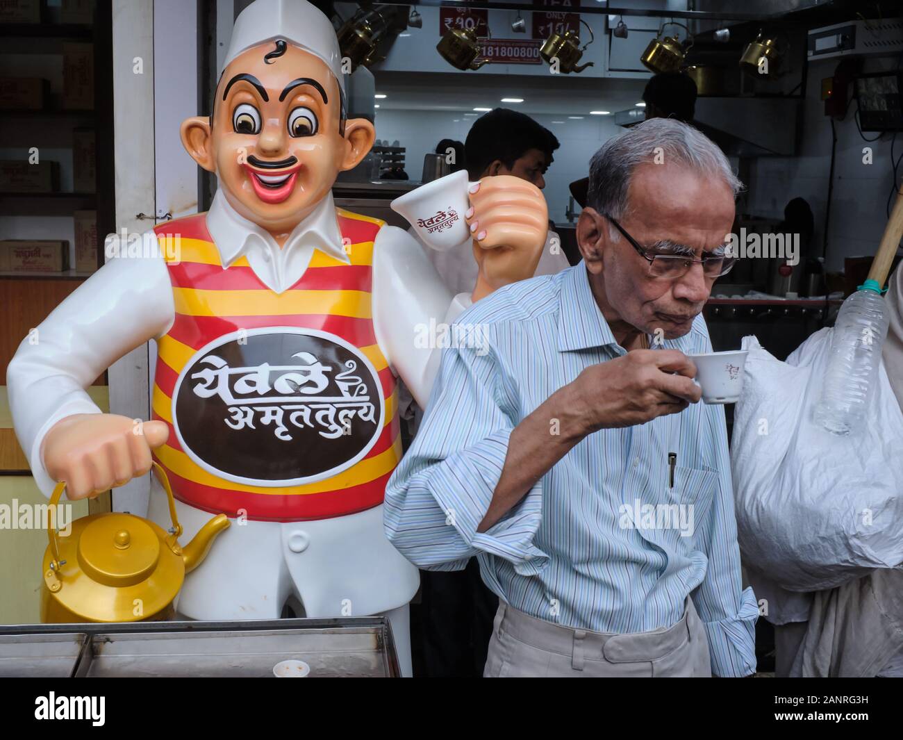A man having a cup of tea at a branch of the Yewale Amruttulya chain of tea shops, in Mumbai