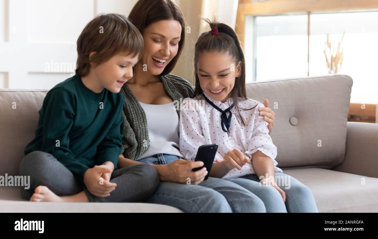 Happy mother and little kids have fun using cell Stock Photo - Alamy