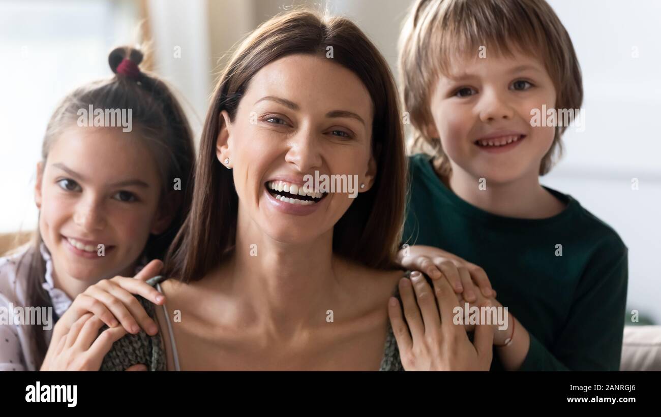 Portrait of happy mom and little kids hugging Stock Photo