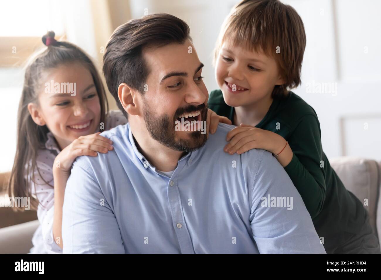 Happy dad have fun playing with kids at home Stock Photo