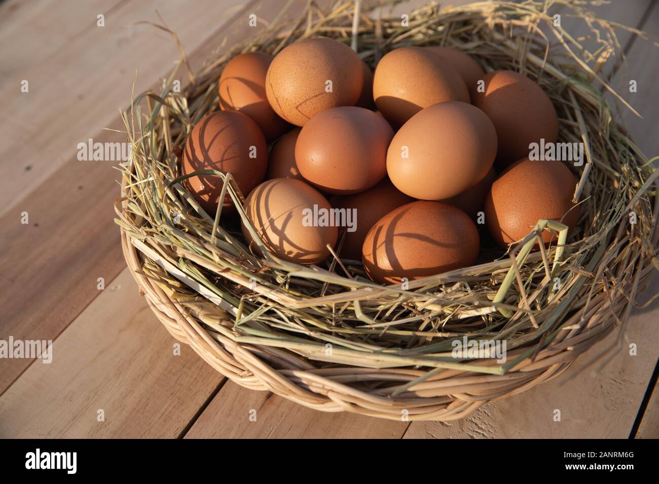 Egg basket on wooden floor Stock Photo