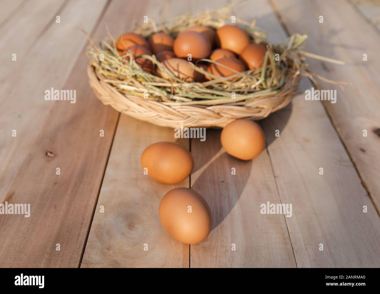 Egg basket on wooden floor Stock Photo