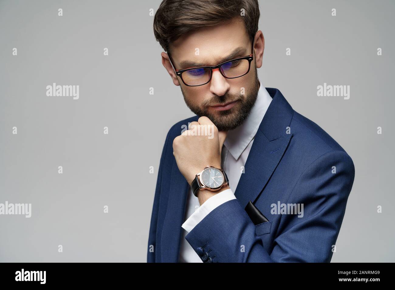 Studuo shot of thinking businessman wearing suit Stock Photo