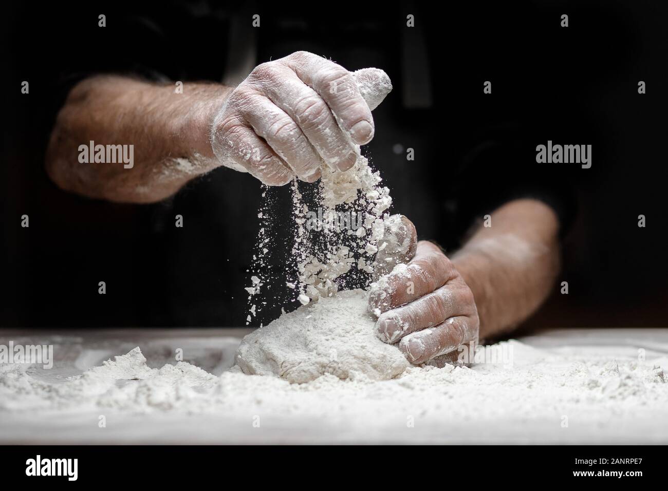 Hands Of Male Baker Preparing Yeast Dough With White Flour Dust On hands-of-male-baker-preparing-yeast-dough-with-white-flour-dust-on