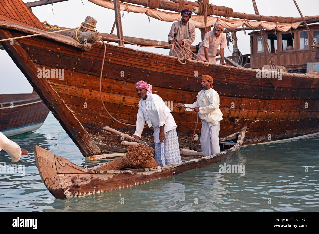 Fishermen using a small wooden boat, Katara Traditional Dhow Festival,  Doha, Qatar Stock Photo - Alamy