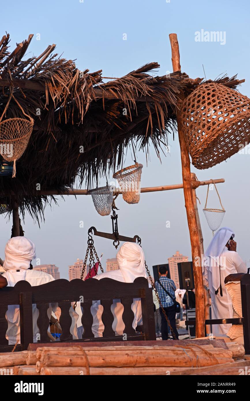 Local men sitting in the traditional fish house, Katara Traditional