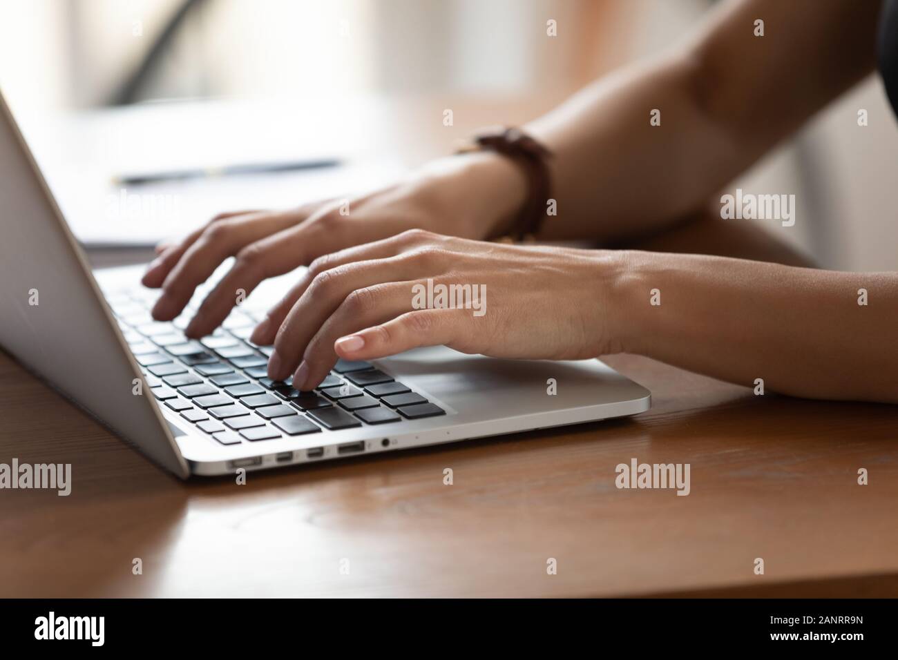 Close up female hands typing on keyboard, using laptop Stock Photo
