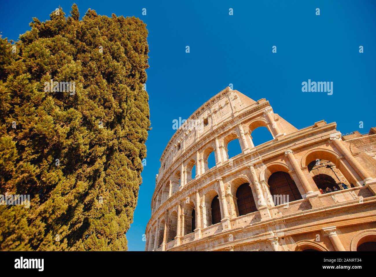 Colosseum or Coliseum ancient ruins background blue sky Rome, Italy ...