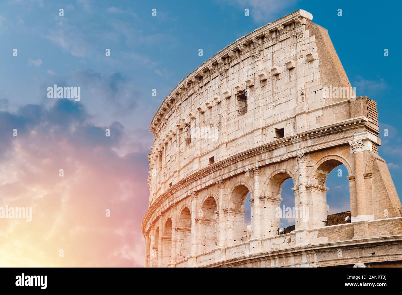 Colosseum or Coliseum ancient ruins background blue sky Rome, Italy ...