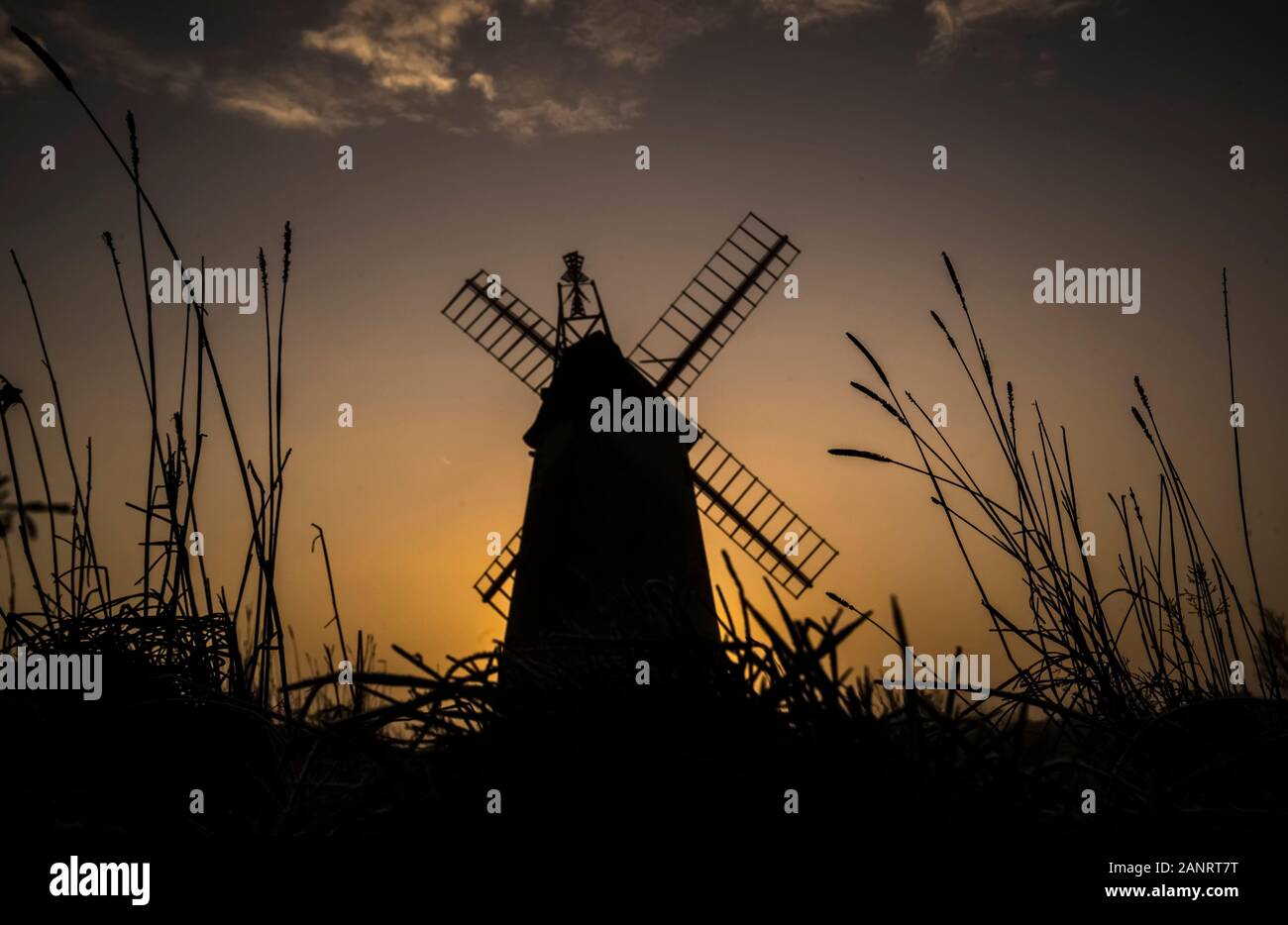 The sun rises behind the Allen Clarke Memorial Windmill in Blackpool, as the chilly weekend continued with the mercury dipping below zero and fog coating large parts of the country. Stock Photo