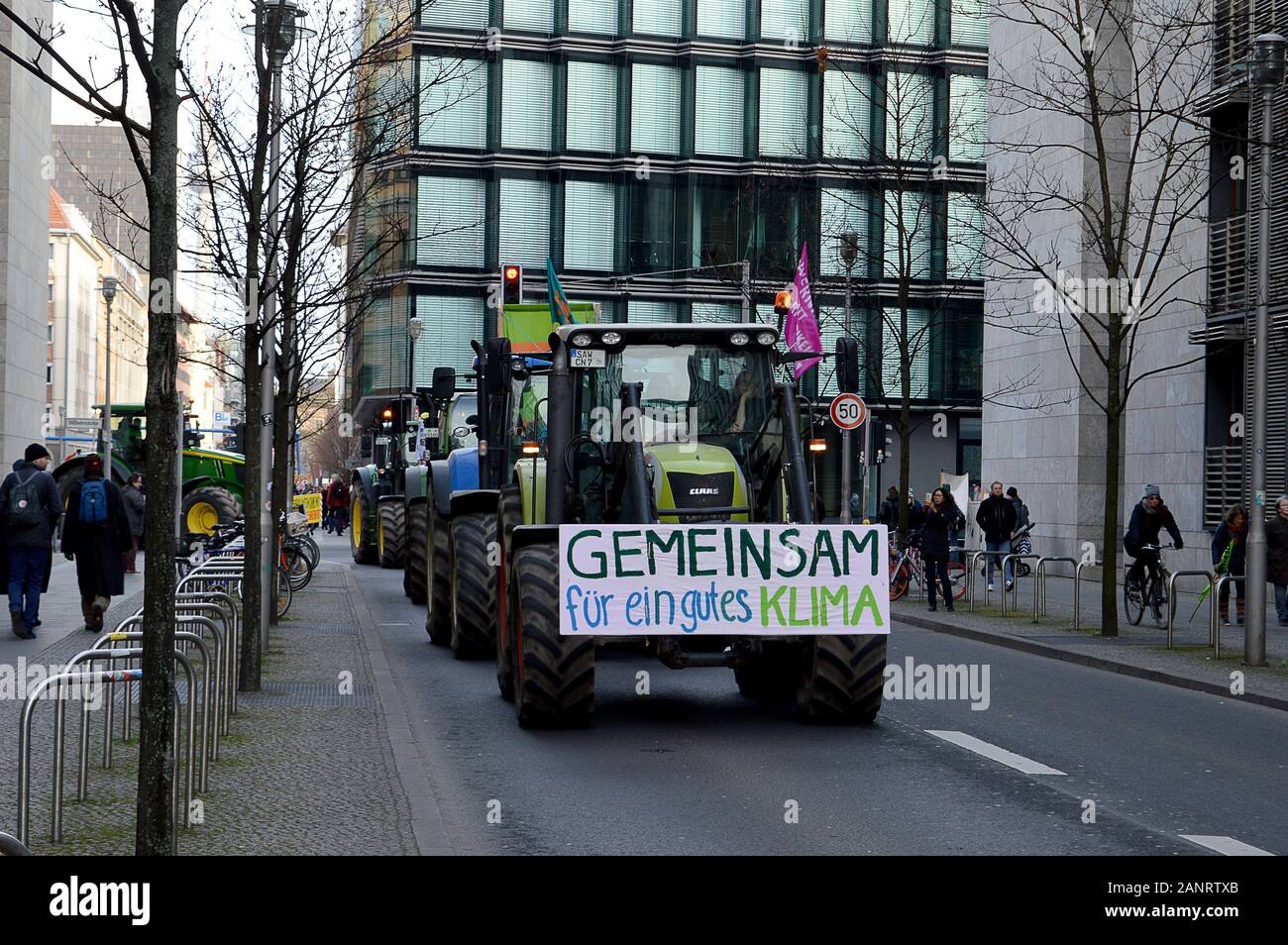 BERLIN, GERMANY - 18 JANUARY 2020: A tractor with a banner 'Together for a Good Climate' drives with a protest convoy from the Brandenburg Gate during International Green Week 2020. Stock Photo