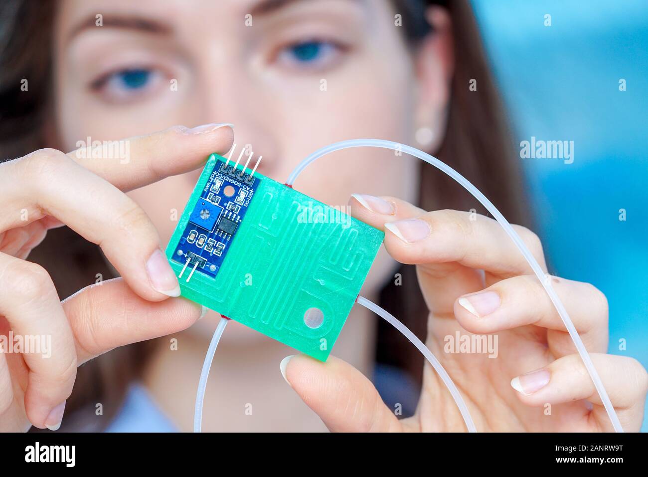 Girl holding polymers Bio-MEMS biomedical microelectromechanical systems / LOC lab-on-a-chip device (concept design) Stock Photo