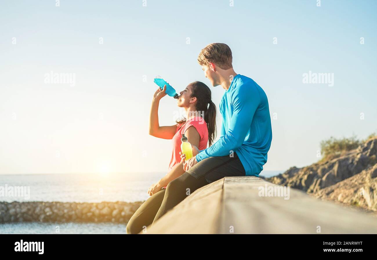 Fitness young couple drinking energy drink outdoor Sporty people