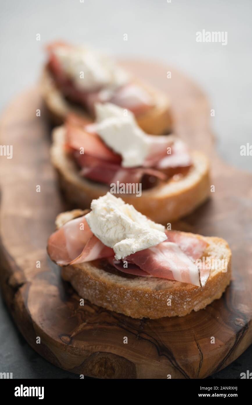 Bruschetta with panchetta, ricotta and fig jam, shallow focus Stock