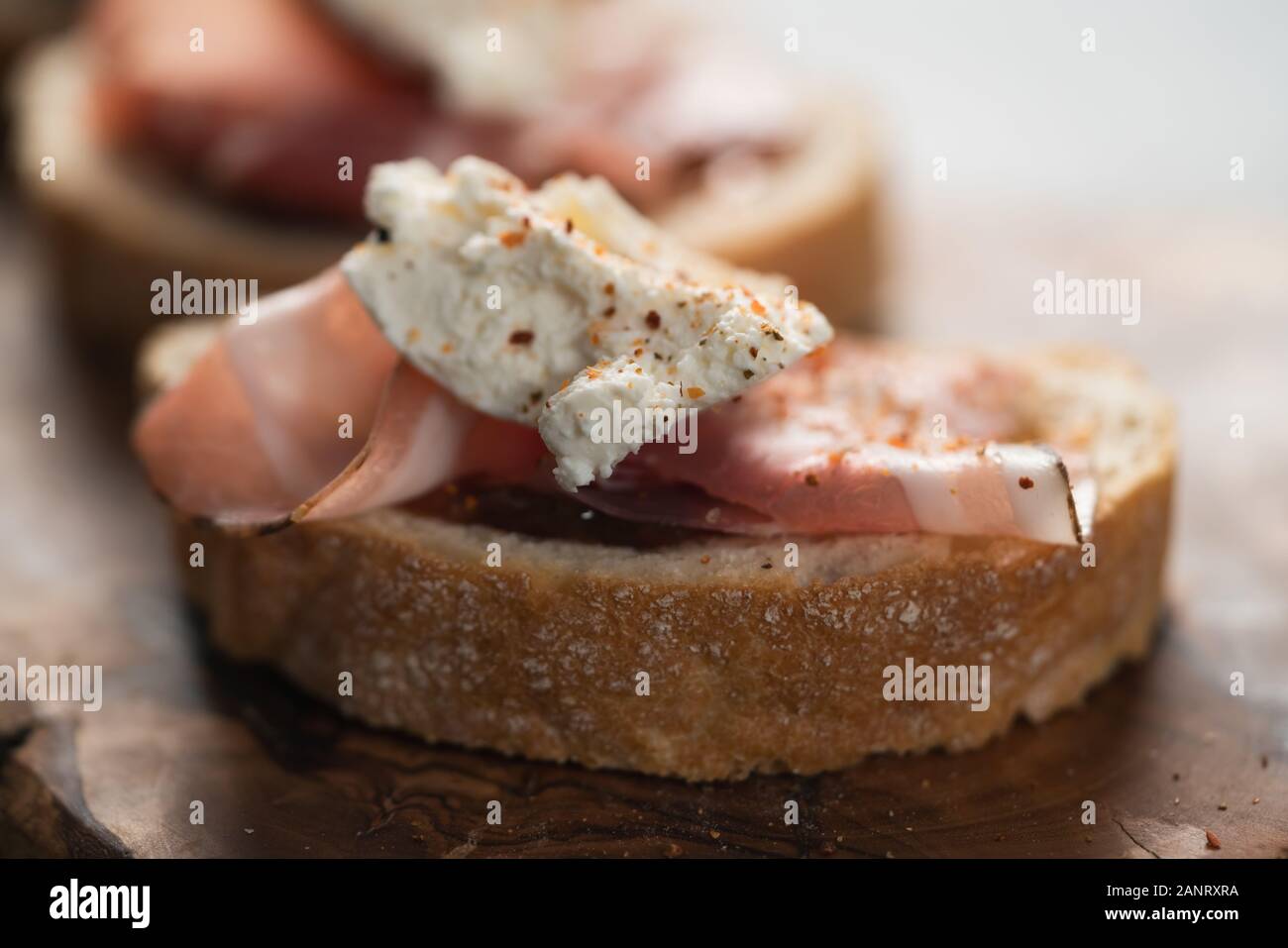 Bruschetta with panchetta, ricotta and fig jam, shallow focus Stock