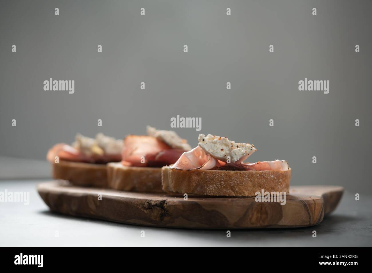 Bruschetta with panchetta, ricotta and fig jam, shallow focus Stock