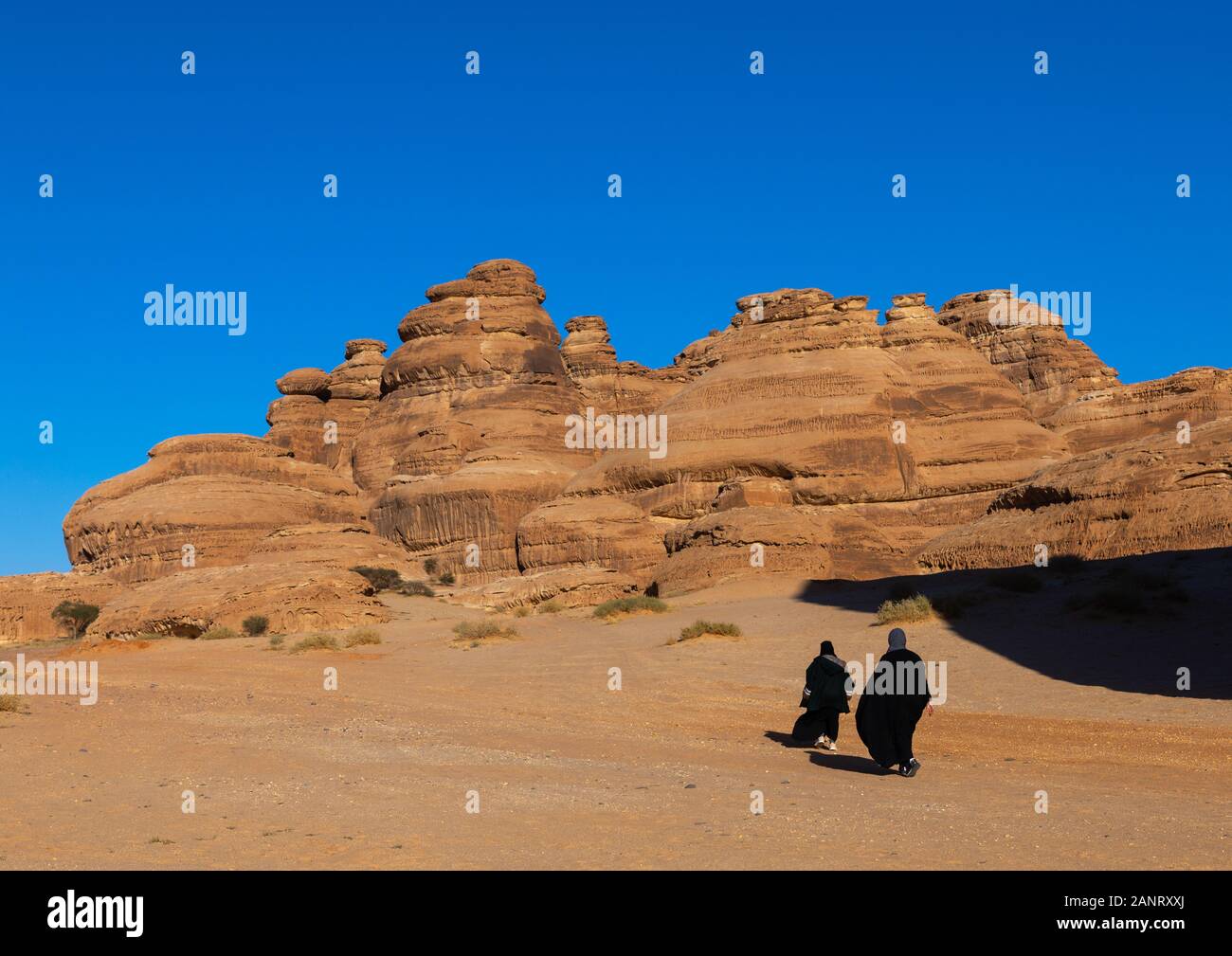 Saudi women in the rocky landscape of Madain Saleh, Al Madinah Province, Alula, Saudi Arabia Stock Photo