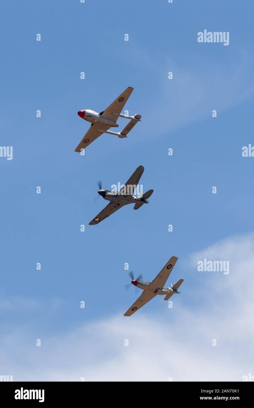 De Havilland Vampire jet aircraft,  Curtiss P-40F and Commonwealth Aircraft Corporation CA-18 Mustang flying in formation. Stock Photo