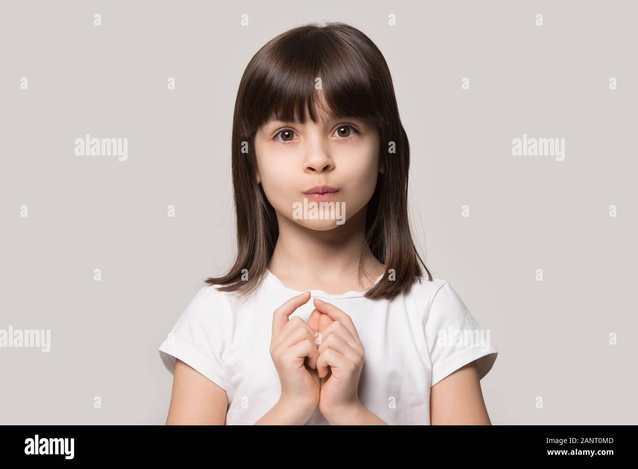 Adorable little curious girl hesitating asking questions. Stock Photo