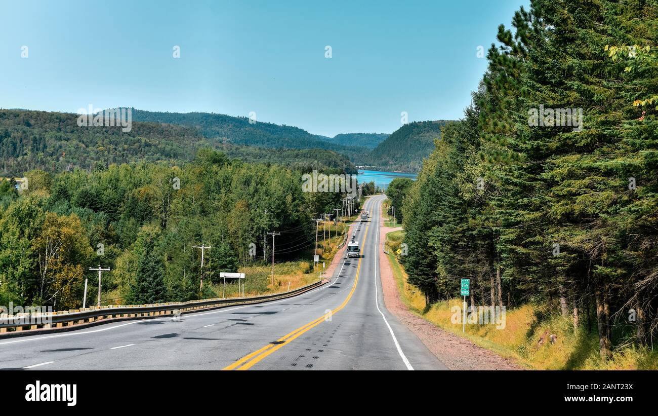 Road between forests and lakes of the Canadian state of Quebec. Stock Photo