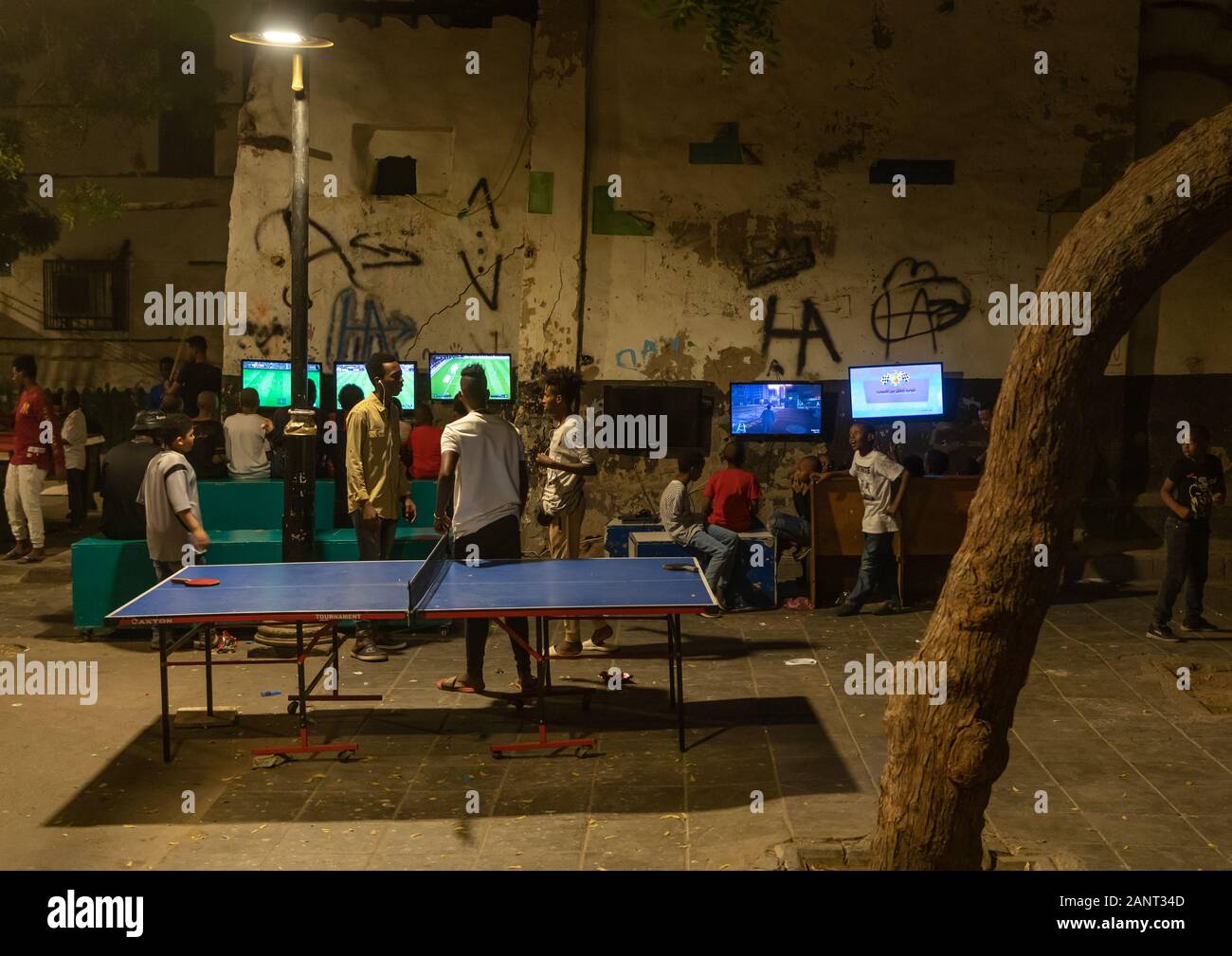 Somali refugees children playing video games in the street in al-Balad quater, Mecca province, Jeddah, Saudi Arabia Stock Photo