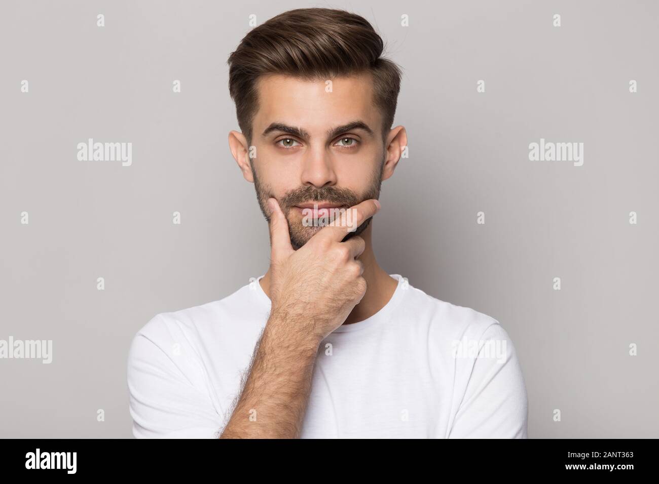 Bearded puzzled man touching hi-res stock photography and images - Alamy