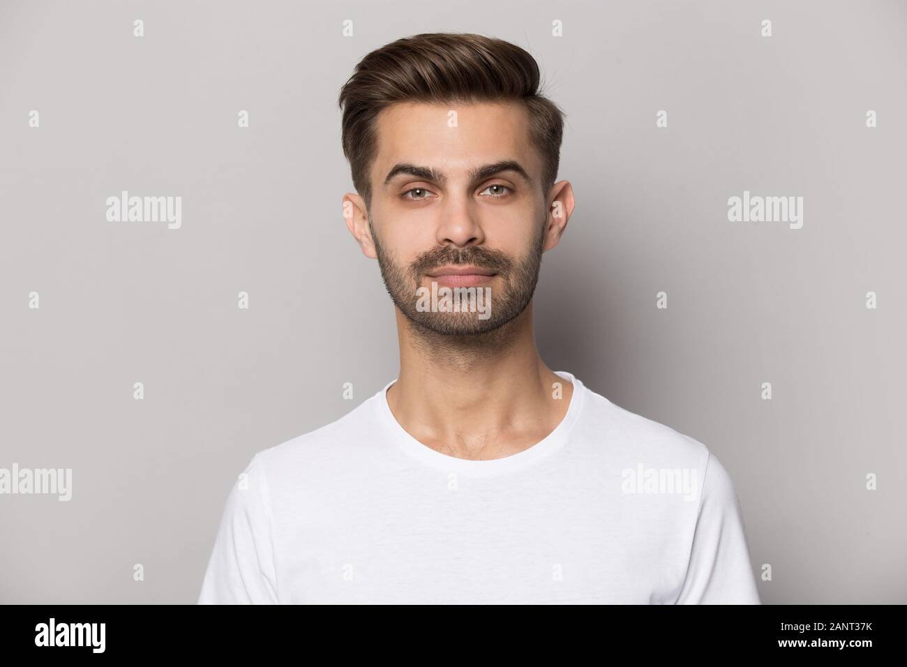 Millennial confident concentrated guy looking at camera portrait. Stock Photo