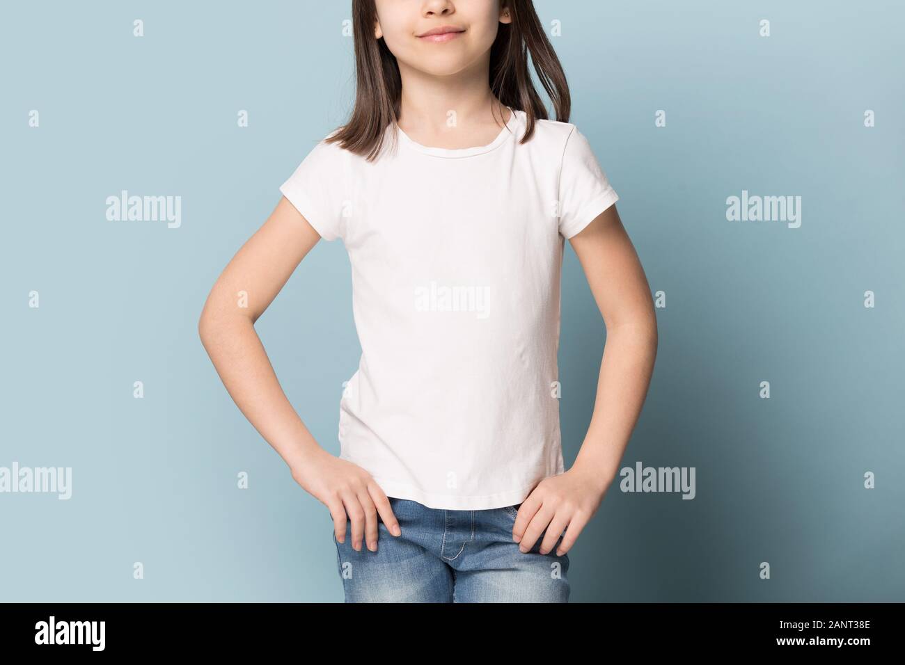 Preschool girl demonstrating white blank mock up copy space t-shirt. Stock Photo