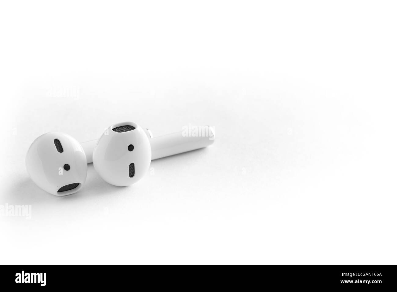 White headphones wireless earphones with case, copy space background