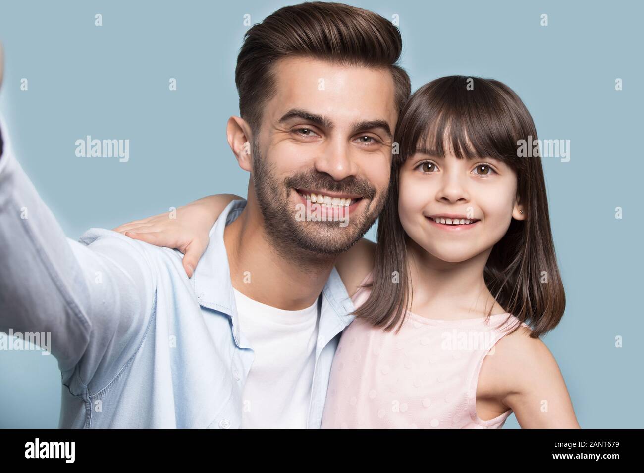 Happy young guy taking selfie shot with sister or daughter. Stock Photo