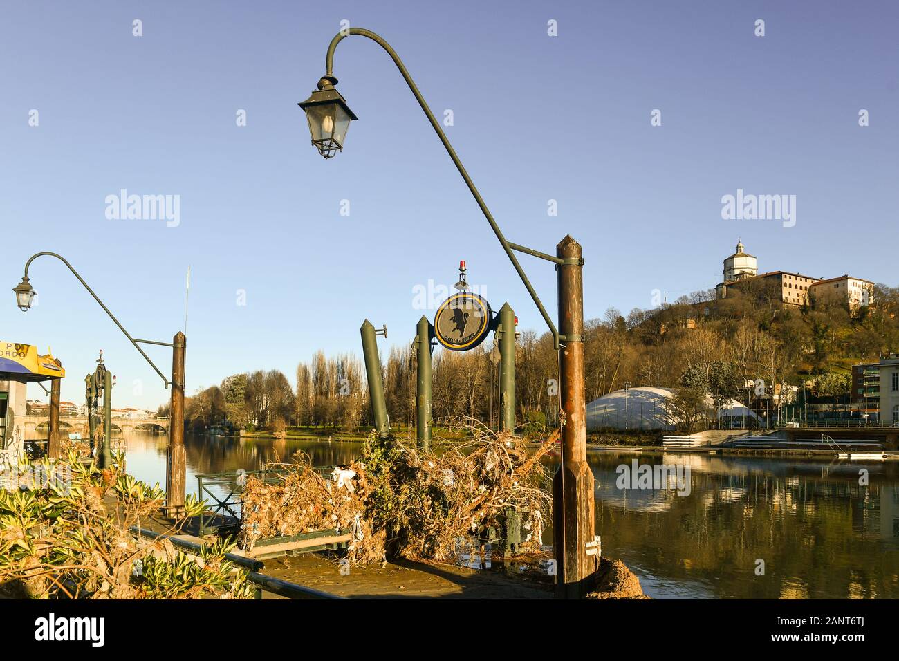 Pier of the Murazzi river bank invaded by rubble of the flood of Po river, with the Monte dei Cappuccini in the background, Turin, Piedmont, Italy Stock Photo