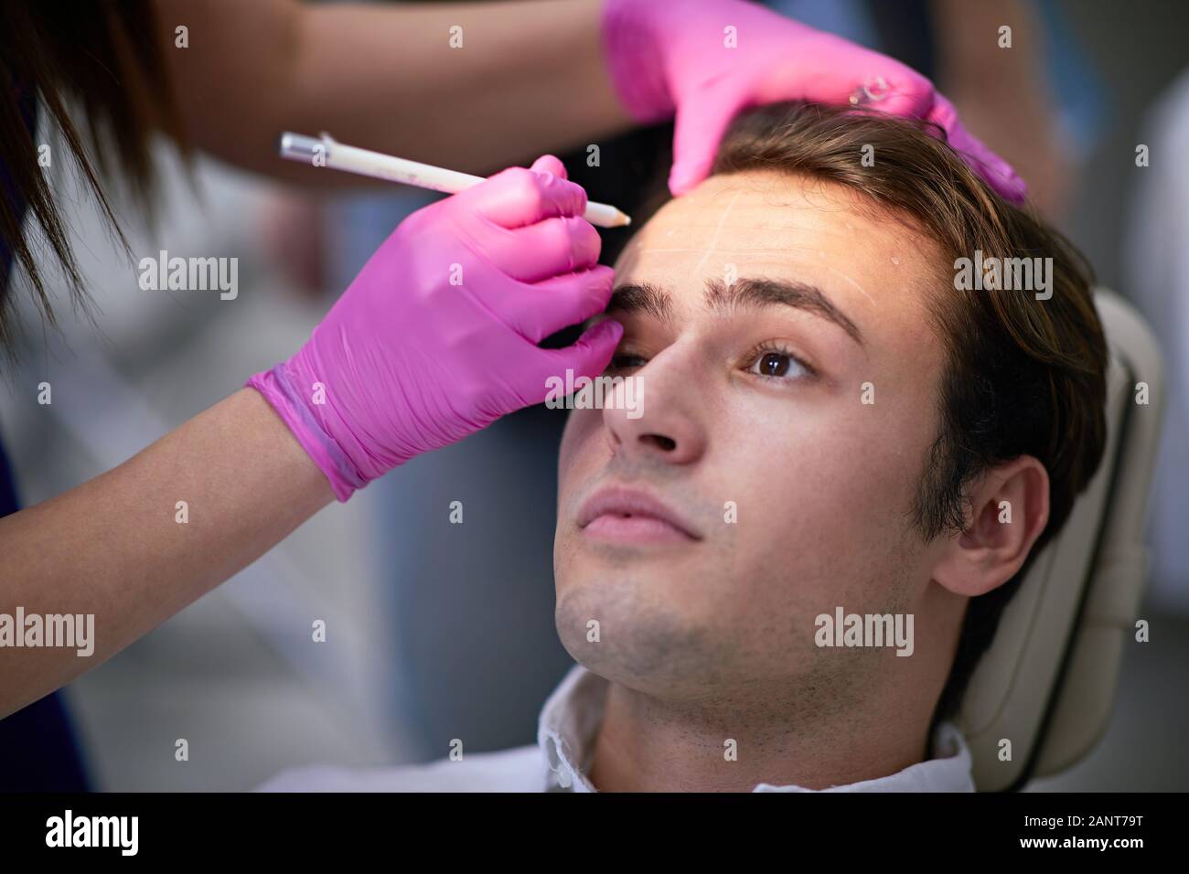 Handsome man having a wrinkle treatment, facial cosmetics concept Stock Photo