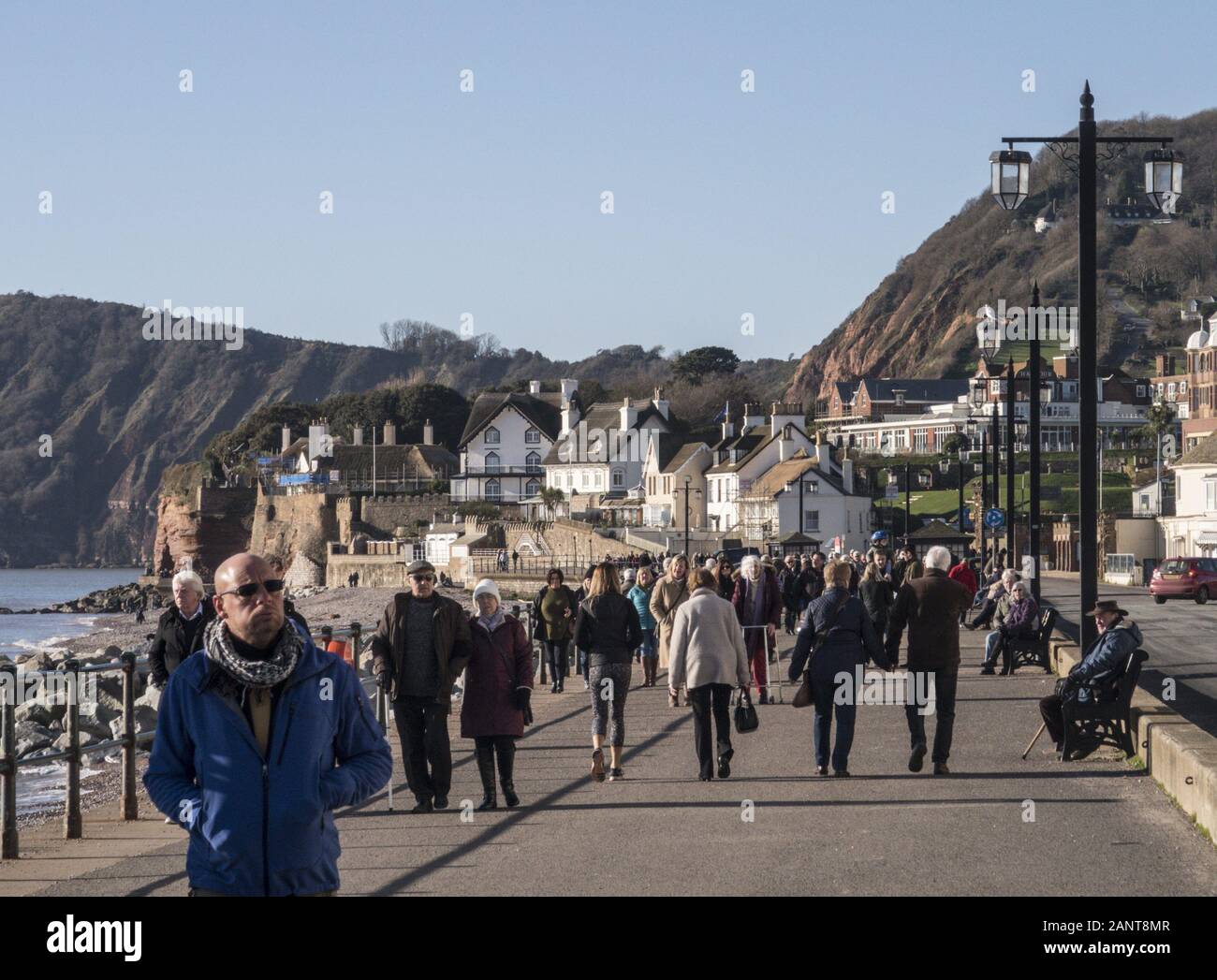 Sidmouth, UK. 19th Jan 2020 People out on Sidmouth Esplanade as extremely high pressure is predicted today by the Met Office.  Readings in the South West to are expected to show 1,050 hectopascals (hPa), a rare high only reached a few times in the last century.This is likely to bring some popping sensation in peoples ears, but the bonus will be fine, clear settled weather for a few days. Photo Central/Alamy Live News Stock Photo