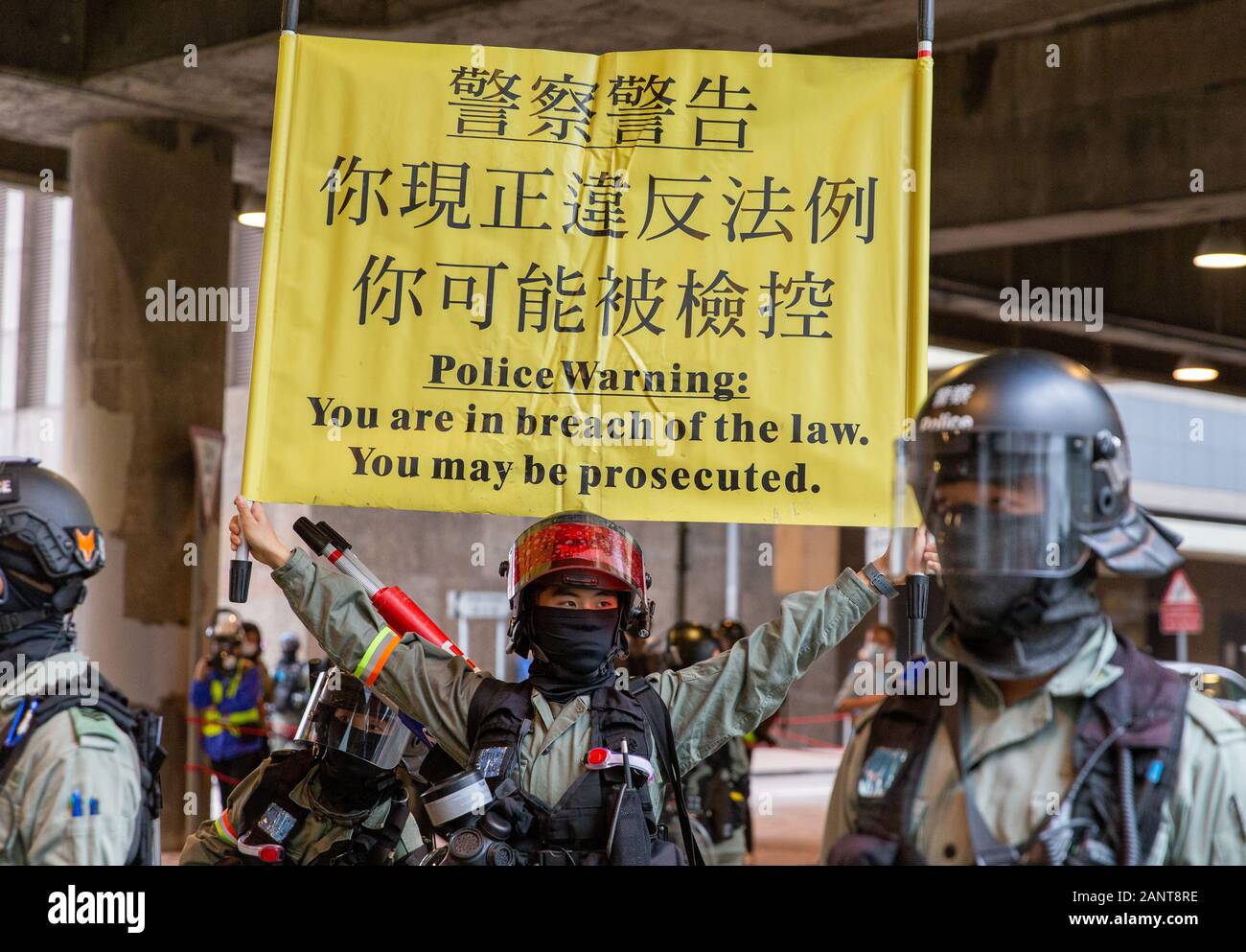 Hong Kong, China. 19th Jan, 2020. Police hold up yellow warning telling crowd to disperse. Hong Kong Protest - Universal Seige on Communists Rally at Chater Garden, Central, Hong Kong. Credit: David Ogg/Alamy Live News Stock Photo