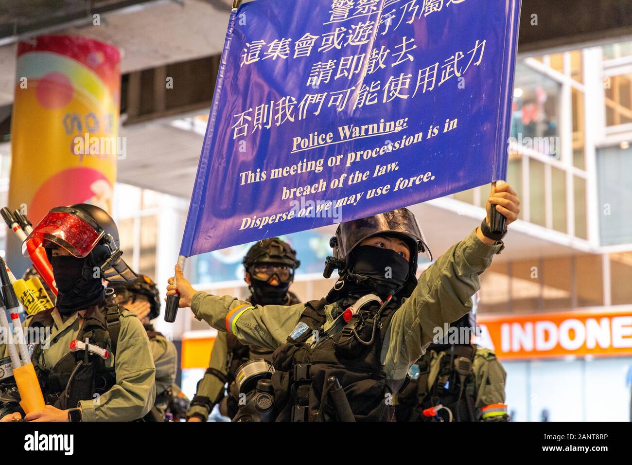 Hong Kong, China. 19th Jan, 2020. Police hold up warning for the crowd to disperse. Next warning is A black flag before tear gas is used. Hong Kong Protest - Universal Seige on Communists Rally at Chater Garden, Central, Hong Kong. Credit: David Ogg/Alamy Live News Stock Photo