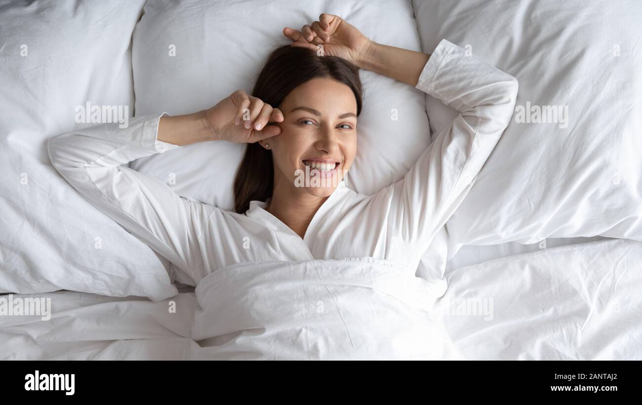 Head Shot Smiling Beautiful Woman Lying In Comfortable Bed Stock