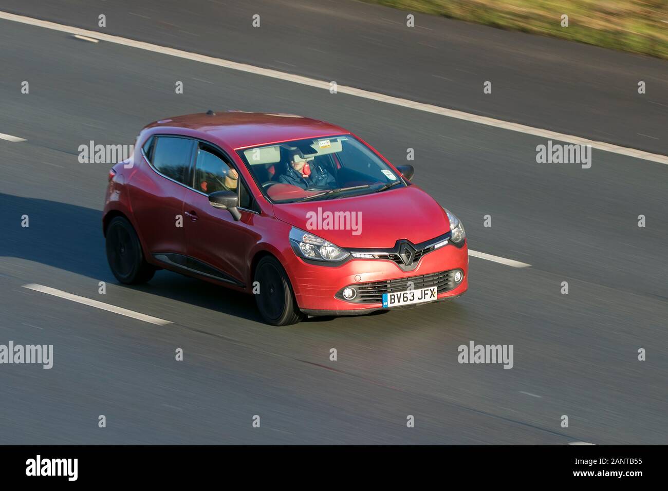 Renault Clio D-Que S M-Nav Nrg Dci S/S Diesel red car driving on the M6 motorway near Preston in Lancashire, UK Stock Photo