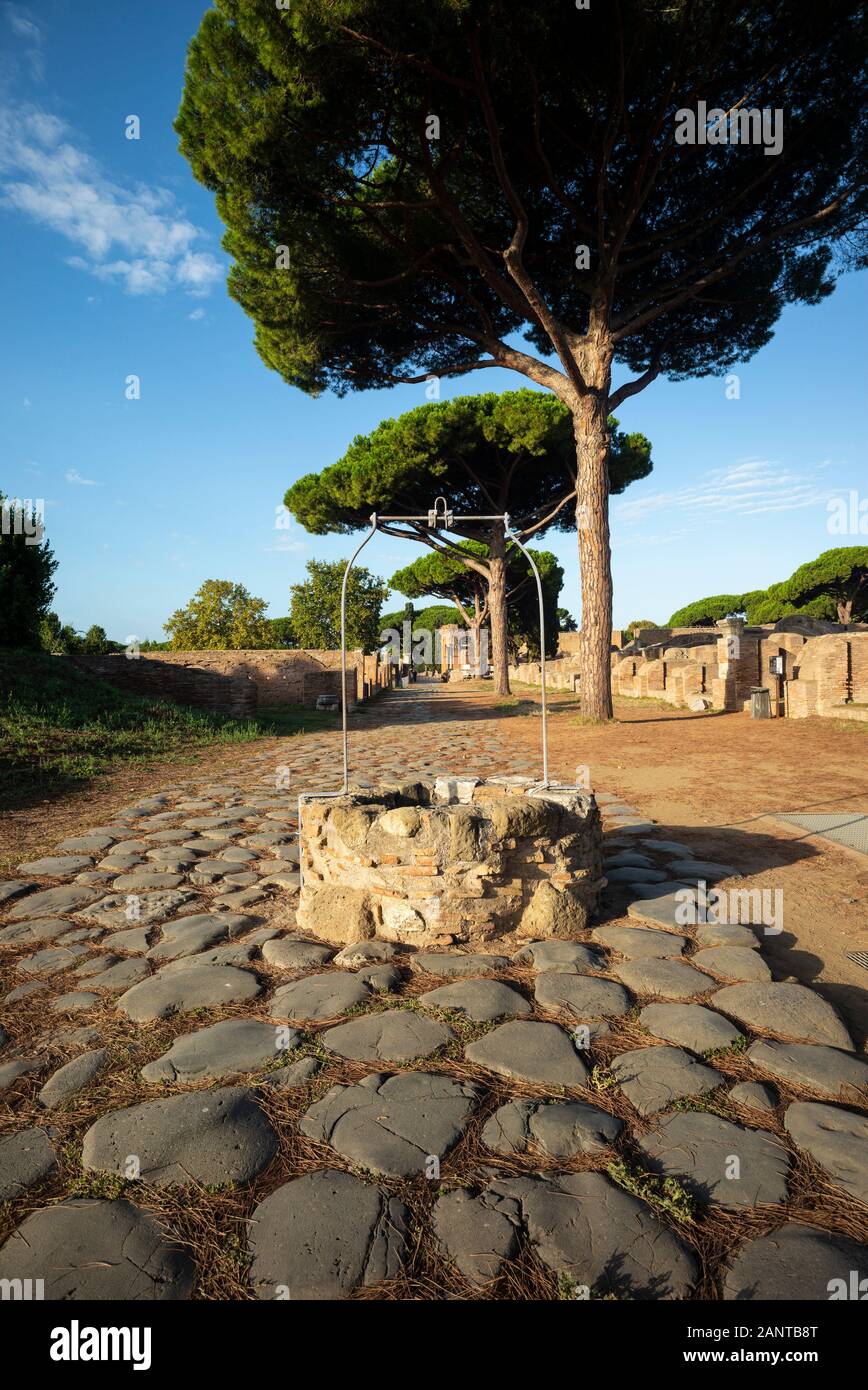 Rome. Italy. Ostia Antica. Decumanus Maximus, the principle Roman road in the east half of Ostia. It runs from east to west, starting at the Porta Rom Stock Photo